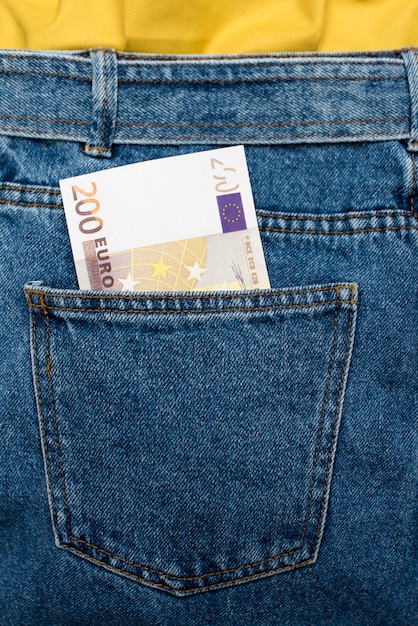 Euro banknotes in jeans back pocket. 