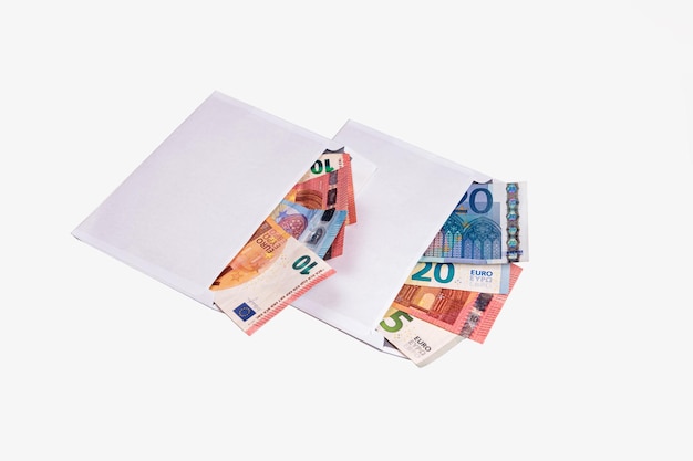 Euro banknotes in open envelopes isolated on white bribe shadow economy and corruption concept