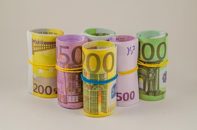 Euro banknotes in rolls are on the table.