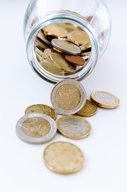 Euro coins scattered from jar