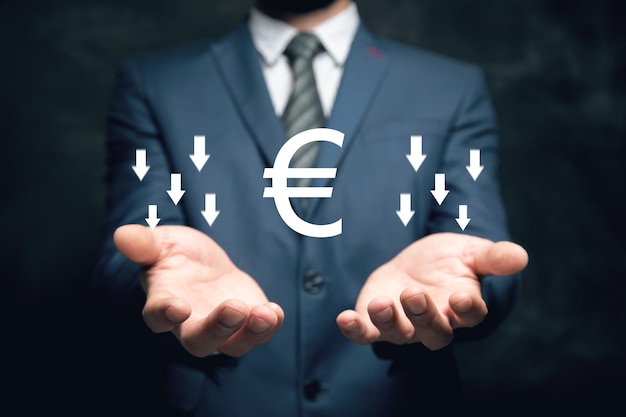 Euro icon with down arrow Falling rate Man holding in his hand