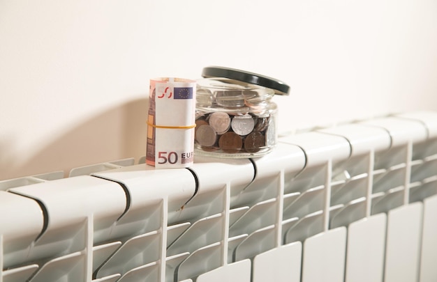 Euro money and coins on heating radiator