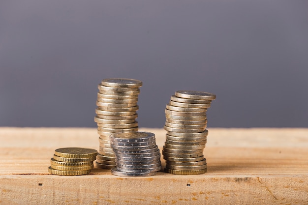 Euro money, currency. Euro coins stack on gray background over wood