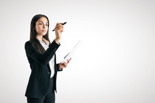 European businesswoman writing something