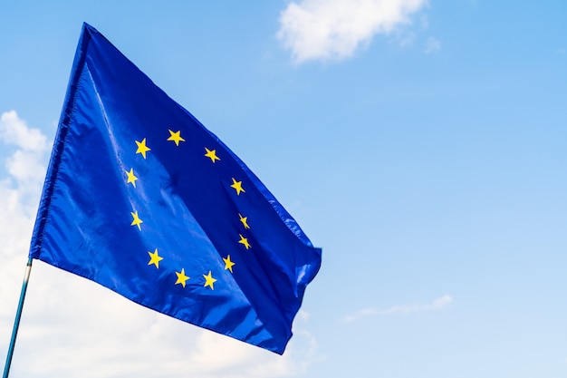 European Union flag against blue sky waving