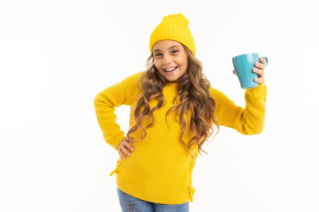 European young girl holding a mug on white