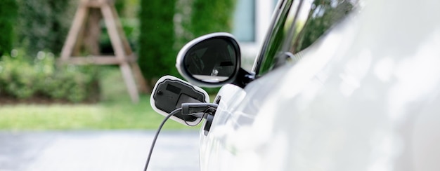 EV car pluggedin with cable from progressive home charging station