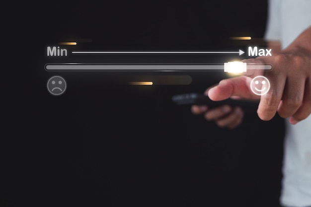 Evaluation and satisfaction concept Feedback level from min to max Close up shot on index finger that points to maximum score