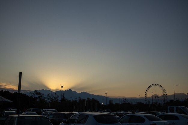 Evening cityscape in the rays of the setting sun and the shadow of the Ferris wheel