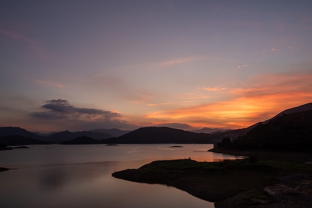 The evening lake reflected the mountains and the sky on both sides;