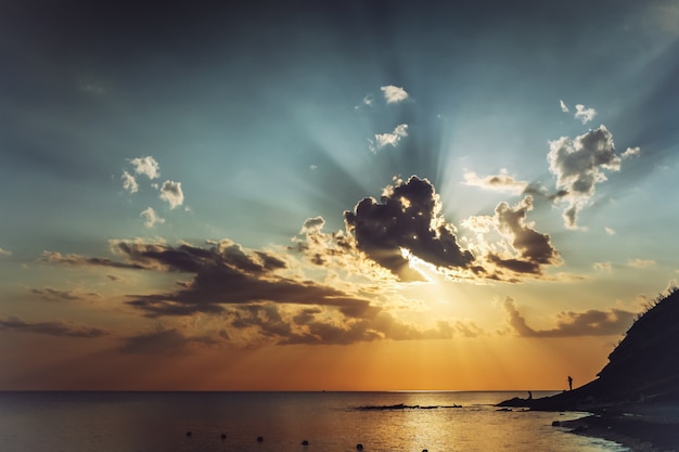 Evening pre-sunset seascape with beautiful clouds and the sun rays in the sky. 