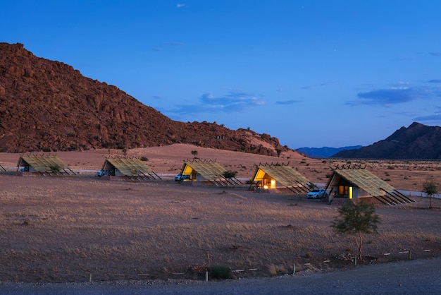 Evening at small chalets of a desert lodge near Sossusvlei in Namibia