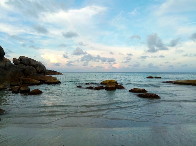 Evening sunset on the beach of a tropical island by the ocean.