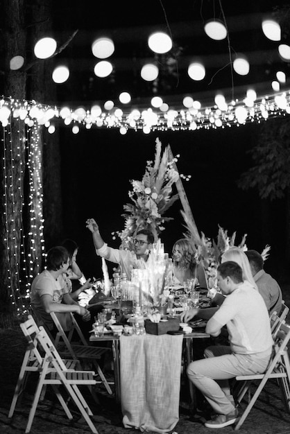 Evening wedding family dinner in the forest