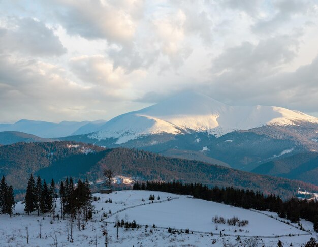 Evening winter cloudy day snow covered alp mountain ridge Ukraine Carpathian Mountains Chornohora Range Hoverla Petros and other mounts scenery view from Yablunytsia pass