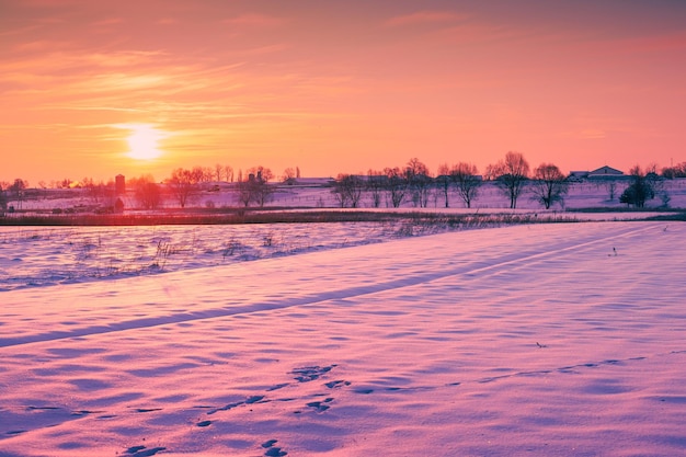 Evening in the winter countryside Arable field sovered with snow