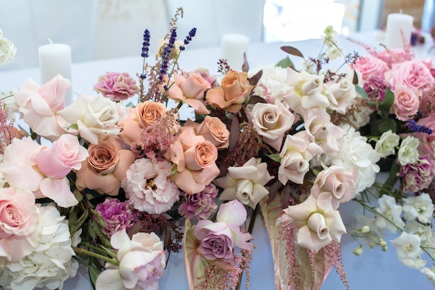 Event white restaurant table served and decorated with delicate fresh flowers