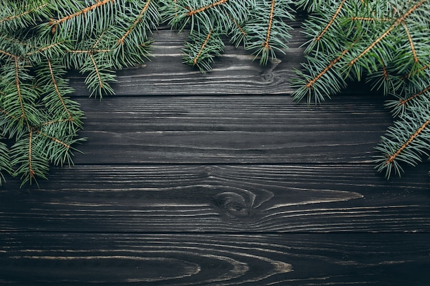 Evergreen Christmas tree on wooden board horizontal view holiday concept.