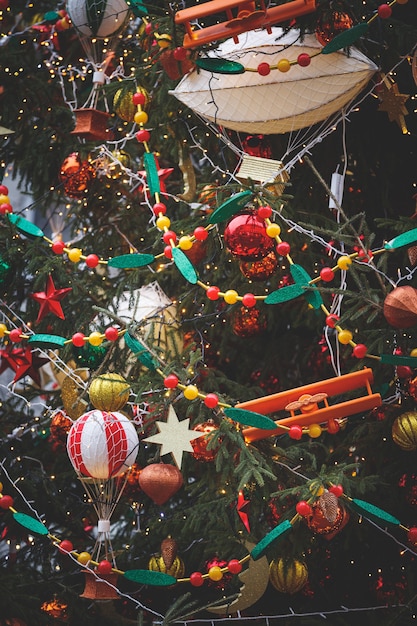 Evergreen tree with a variety of toys and sparkling garlands in the center of Moscow