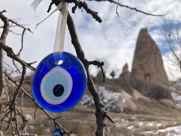 Evil eye - traditional Turkish souvenir tied up on a tree branch in Cappadocia. Turkey.