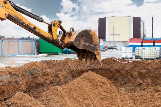 Excavator bucket close up Excavation work at construction site and road construction Construction machinery