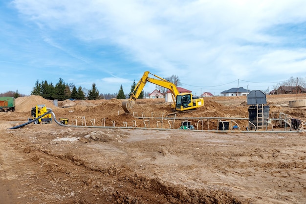 Excavator dig the trenches at a construction site Trench for laying external sewer pipes Sewage drainage system for a multistory building Digging the pit foundation