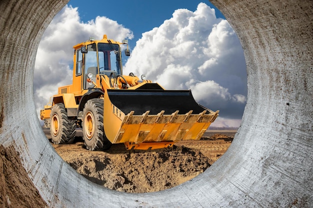 The excavator loader works with a bucket for transporting sand at a construction site Professional construction equipment for earthworks