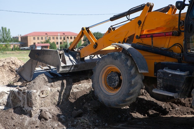 Excavator and new building in the field