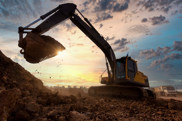 Excavator at sandpit during earthmoving works in the construction site.