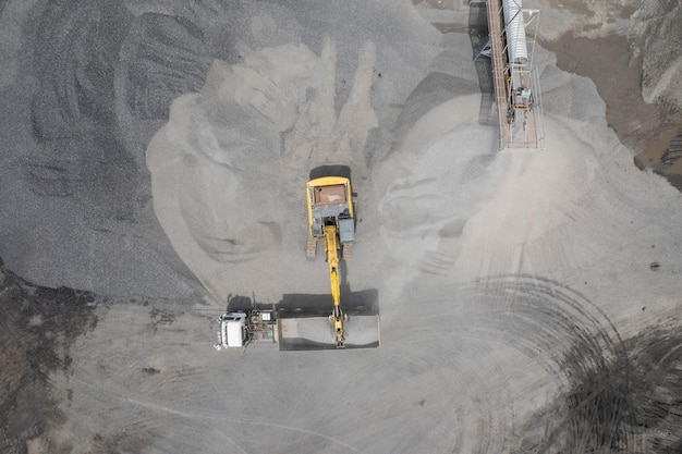 Excavator scooping rocks stone construction