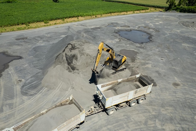 Excavator scooping rocks stone construction