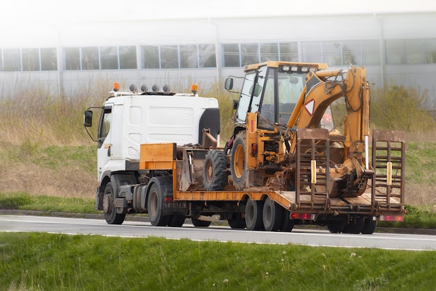 Excavator Transported by Flatbed Truck to Urban Construction Site