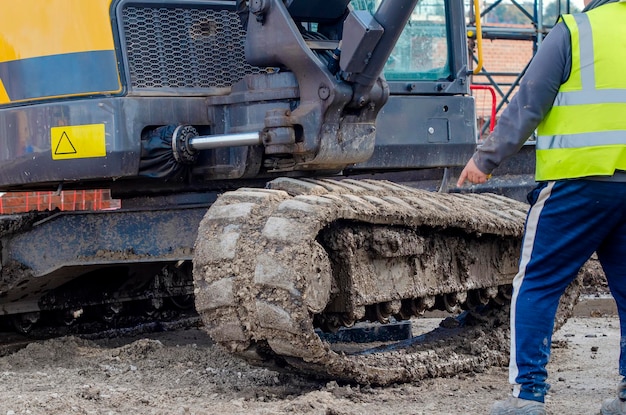 Excavator with broken track in need of repair