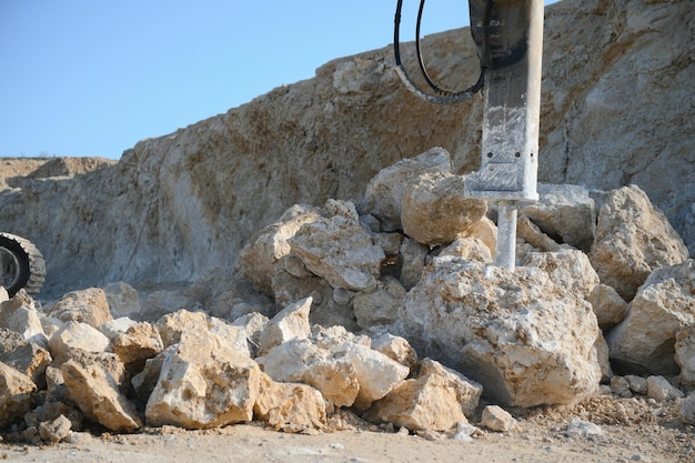 Photo excavator with hydraulic hammer on road construction works