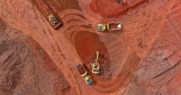 Excavator working backhoe digs ground of preparation process for new residential complex buildings with construction