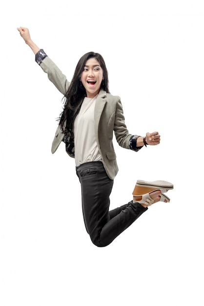 Excited asian business woman raised arm and jump to the sky