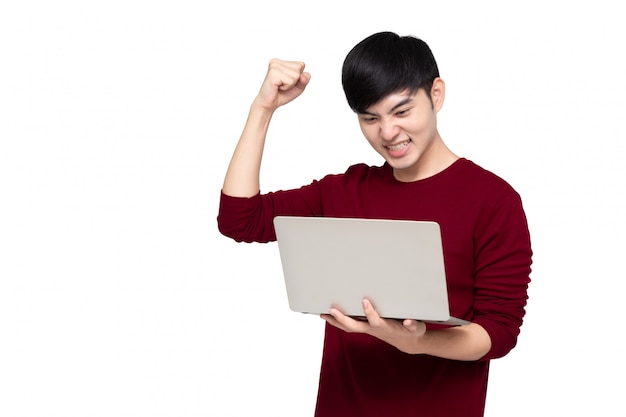 Excited Asian man looking at laptop computer