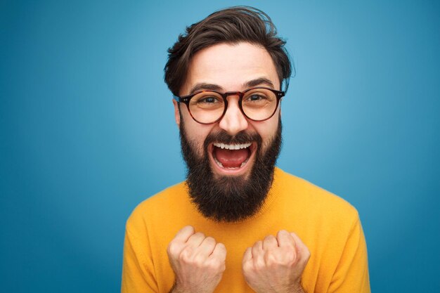 Excited bearded man in glasses