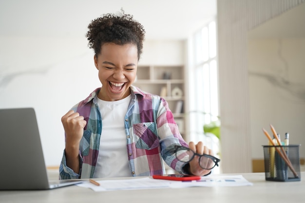 Excited biracial girl student celebrates victory got email with good scores Personal achievement