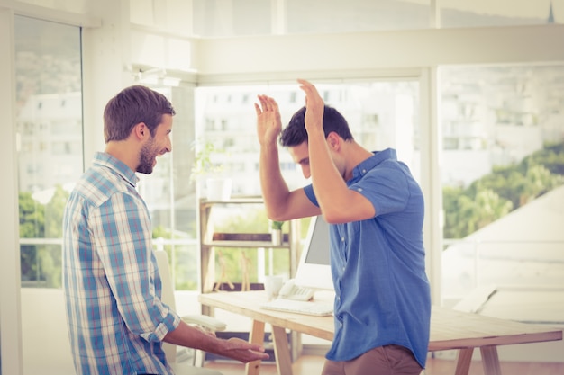 Excited businessmen clapping their hands