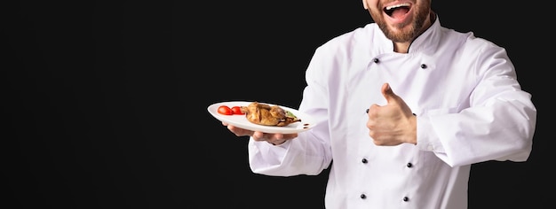 Excited Chef Showing Chicken Dish Gesturing ThumbsUp Black Background Panorama