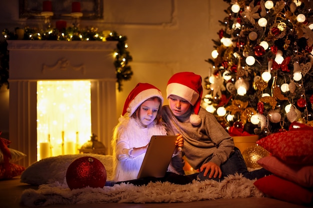 Excited children near Christmas tree