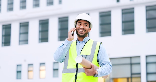 Excited confident and happy architect talking on phone agreeing to building plan for office development in city Cheerful ambitious contractor or surveryor negotiating blueprint deal on technology