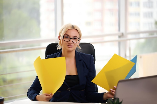 Excited executive wearing suit raising arms watching a desktop computer monitor at office