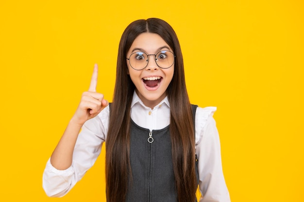 Excited face cheerful emotions of teenager girl Funny face of young teenager pointing up with finger