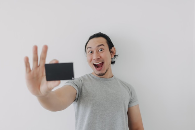 Excited face of man showing black mockup card in his hand