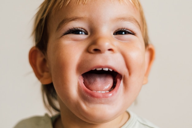 Excited face of a small baby toddler on white background