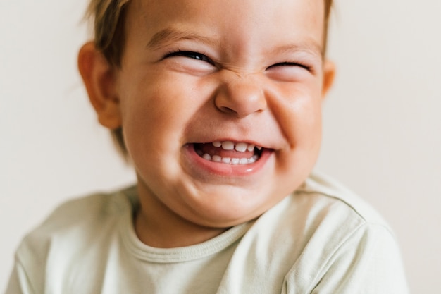 Excited face of a small baby toddler on white background