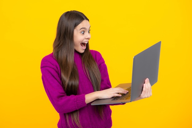 Excited face Young student school girl studying with laptop computer Elearning concept Amazed