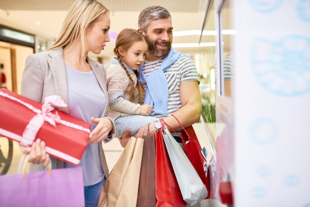 Excited family looking at window in mall